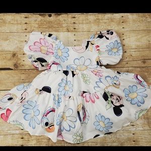 Adorable Disney dress with puffy sleeves and a layer of tulle for a full look